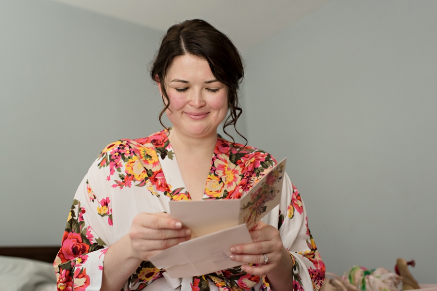 An emotional bride reads a letter from her fiance before the wedding.